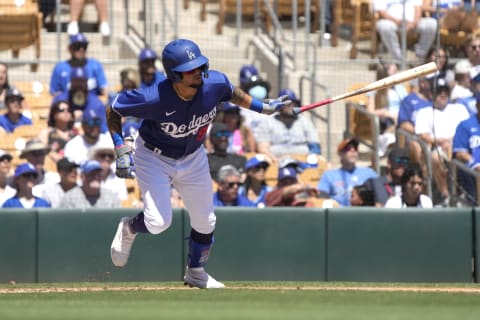 Los Angeles Dodgers left fielder Andy Pages (90) hits an RBI single. Mandatory Credit: Rick Scuteri-USA TODAY Sports