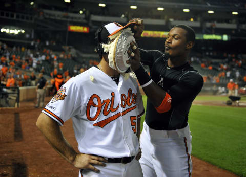 Sep 3, 2014; Baltimore, MD, USA; Baltimore Orioles starting pitcher Miguel Gonzalez (50) gets a pie in the face from Adam Jones after pitching a complete game shutout against the Cincinnati Reds at Oriole Park at Camden Yards. The Orioles defeated the Reds 6-0. Mandatory Credit: Joy R. Absalon-USA TODAY Sports