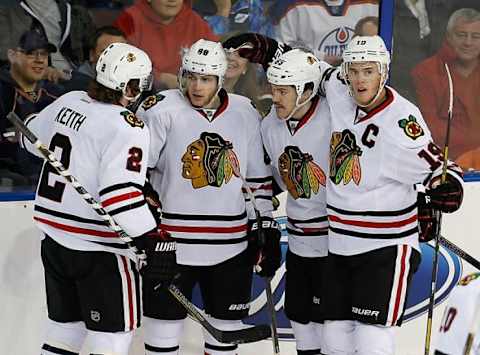 Nov 25, 2013; Edmonton, Alberta, CAN; Chicago Blackhawks defenseman Duncan Keith (2), Andrew Shaw (65) and forward Jonathan Toews (19) celebrate a goal by forward Patrick Kane (88) against the Edmonton Oilers at Rexall Place. Mandatory Credit: Perry Nelson-USA TODAY Sports