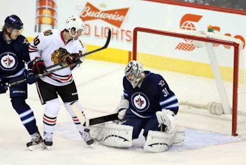 Nov 21, 2013; Winnipeg, Manitoba, CAN; Winnipeg Jets goalie Ondrej Pavelec (31) makes a save against the Chicago Blackhawks during the first period at MTS Centre. Mandatory Credit: Bruce Fedyck-USA TODAY Sports