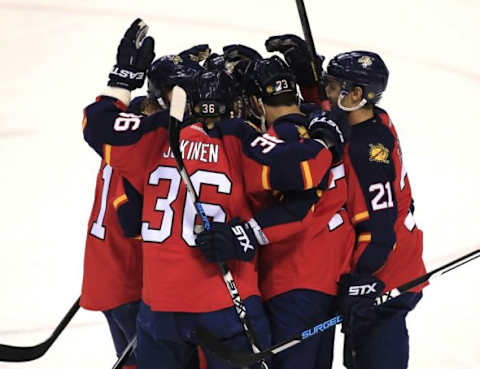 Jan 2, 2016; Sunrise, FL, USA; Florida Panthers center Vincent Trocheck (21) celebrates his goal with left wing Jussi Jokinen (36)center Brandon Pirri (73) and defenseman Brian Campbell (left) after his goal against the New York Rangers in the second period at BB&T Center. Mandatory Credit: Robert Mayer-USA TODAY Sports