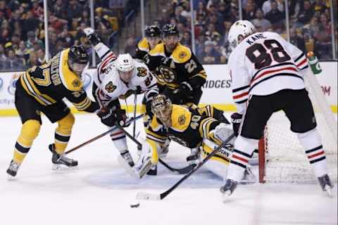 Dec 11, 2014; Boston, MA, USA; Chicago Blackhawks right wing Patrick Kane (88) takes a shot at Boston Bruins goalie Tuukka Rask (40) while right wing Kris Versteeg (23) is up ended by defenseman Dougie Hamilton (27) during the second period at TD Banknorth Garden. Mandatory Credit: Greg M. Cooper-USA TODAY Sports