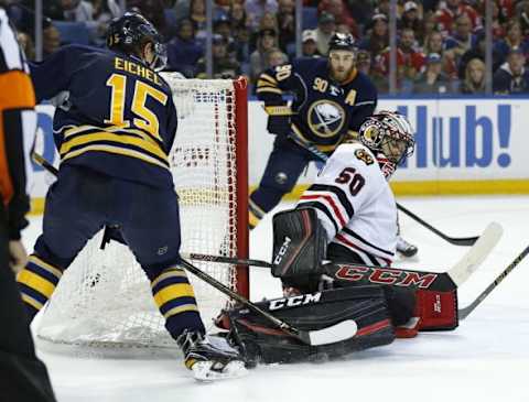 Dec 19, 2015; Buffalo, NY, USA; Chicago Blackhawks goalie Corey Crawford (50) makes a pad save on a shot by Buffalo Sabres center Jack Eichel (15) during the third period at First Niagara Center. Blackhawks beat the Sabres 3-2 in a shootout. Mandatory Credit: Kevin Hoffman-USA TODAY Sports