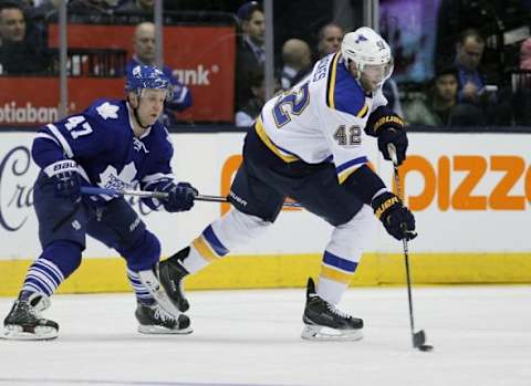 Jan 2, 2016; Toronto, Ontario, CAN; St. Louis Blues forward David Backes (42) passes the puck to St. Louis Blues forward Vladimir Tarasenko (not pictured) who scores as Toronto Maple Leafs forward Leo Komarov (47) defends during the second period at the Air Canada Centre. Mandatory Credit: John E. Sokolowski-USA TODAY Sports