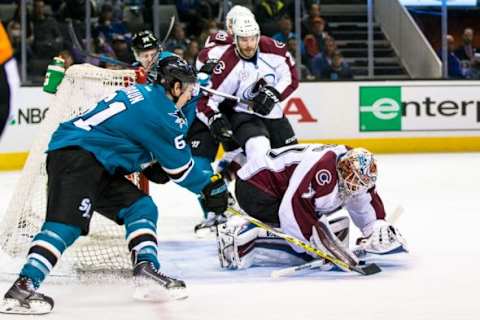 Jan 26, 2016; San Jose, CA, USA; Colorado Avalanche goalie Calvin Pickard (31) deflects a shot by San Jose Sharks defenseman Justin Braun (61) in the 2nd period at SAP Center at San Jose. Mandatory Credit: John Hefti-USA TODAY Sports.