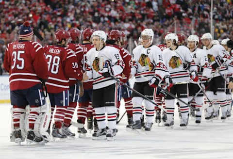 Jan 1, 2015; Washington, DC, USA; Chicago Blackhawks right wing Patrick Kane (88) and center Jonathan Toews (19) shake hands with Washington Capitals players after the 2015 Winter Classic hockey game at Nationals Park. Mandatory Credit: Geoff Burke-USA TODAY Sports