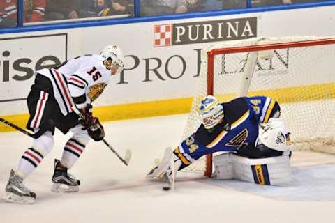 Mar 9, 2016; St. Louis, MO, USA; St. Louis Blues goalie Jake Allen (34) blocks the shot of Chicago Blackhawks center Artem Anisimov (15) during the third period at Scottrade Center. The St. Louis Blues defeat the Chicago Blackhawks 3-2 in a shootout. Mandatory Credit: Jasen Vinlove-USA TODAY Sports