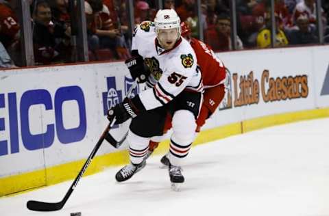 Mar 2, 2016; Detroit, MI, USA; Chicago Blackhawks defenseman Christian Ehrhoff (55) skates with the puck chased by Detroit Red Wings center Gustav Nyquist (14) in the first period at Joe Louis Arena. Mandatory Credit: Rick Osentoski-USA TODAY Sports