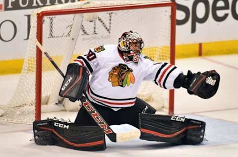 Mar 9, 2016; St. Louis, MO, USA; Chicago Blackhawks goalie Corey Crawford (50) makes a glove save against the St. Louis Blues during the third period at Scottrade Center. The St. Louis Blues defeat the Chicago Blackhawks 3-2 in a shootout. Mandatory Credit: Jasen Vinlove-USA TODAY Sports