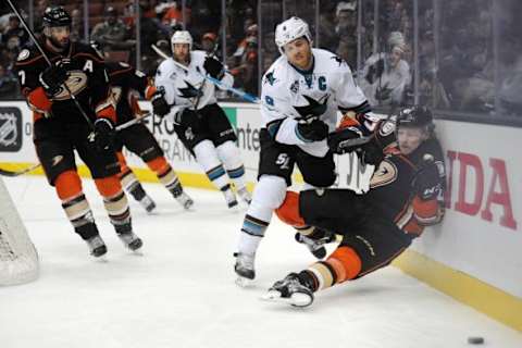 February 2, 2016; Anaheim, CA, USA; Anaheim Ducks defenseman Hampus Lindholm (47) is hit against the boards by San Jose Sharks center Joe Pavelski (8) during the third period at Honda Center. Mandatory Credit: Gary A. Vasquez-USA TODAY Sports