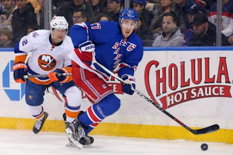 Mar 6, 2016; New York, NY, USA; New York Rangers defenseman Ryan McDonagh (27) plays the puck in front of New York Islanders left wing Josh Bailey (12) during the third period at Madison Square Garden. The Islanders defeated the Rangers 6-4. Mandatory Credit: Brad Penner-USA TODAY Sports