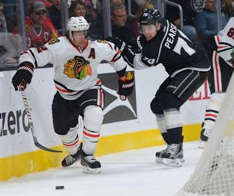 Nov 28, 2015; Los Angeles, CA, USA; Los Angeles Kings left wing Tanner Pearson (70) and Chicago Blackhawks defenseman Duncan Keith (2) chase down the puck in the third period of the game at Staples Center. Kings won 3-2. Mandatory Credit: Jayne Kamin-Oncea-USA TODAY Sports