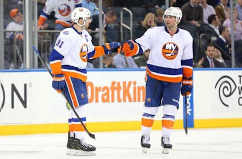 Apr 7, 2016; New York, NY, USA; New York Islanders center John Tavares (91) celebrates with defenseman Johnny Boychuk (55) after scoring on an empty-net goal against the New York Rangers during the third period at Madison Square Garden. The Islanders won 4-1. Mandatory Credit: Brad Penner-USA TODAY Sports