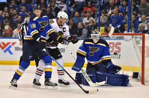 Apr 13, 2016; St. Louis, MO, USA; St. Louis Blues goalie Brian Elliott (1) blocks a shot behind the screen of Chicago Blackhawks center Jonathan Toews (19) during the first period in game one of the first round of the 2016 Stanley Cup Playoffs at Scottrade Center. Mandatory Credit: Jasen Vinlove-USA TODAY Sports