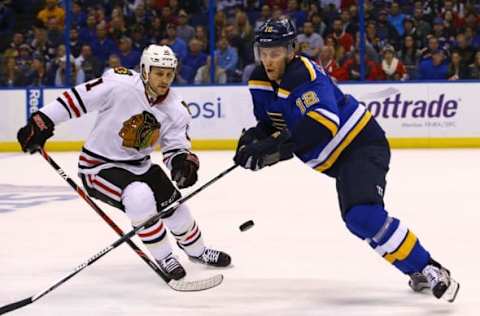 Apr 15, 2016; St. Louis, MO, USA; St. Louis Blues center Jori Lehtera (12) and Chicago Blackhawks center Andrew Desjardins (11) reach for a loose puck during the first period in game two of the first round of the 2016 Stanley Cup Playoffs at Scottrade Center. Mandatory Credit: Billy Hurst-USA TODAY Sports