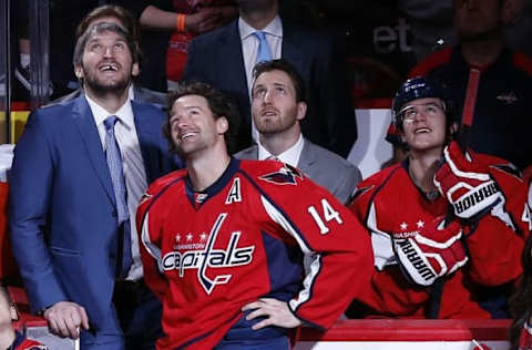 Apr 10, 2016; Washington, DC, USA; Washington Capitals right wing Justin Williams (14) stands with (from left to right) Capitals left wing Alex Ovechkin, Capitals defenseman Brooks Orpik, and Capitals center Michael Latta (46) during a ceremony honoring Williams