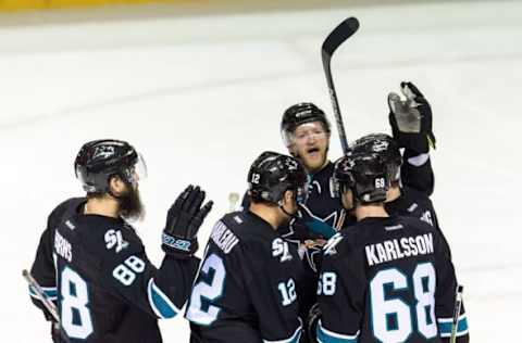 Apr 7, 2016; San Jose, CA, USA; San Jose Sharks defenseman Paul Martin (7) and right wing Melker Karlsson (68) and defenseman Brent Burns (88) celebrate after center Patrick Marleau (12) scores a goal against the Winnipeg Jets in the third period at SAP Center at San Jose. Winnipeg won 5-4. Mandatory Credit: John Hefti-USA TODAY Sports