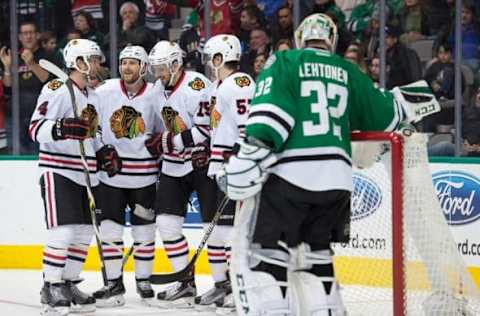 Feb 6, 2016; Dallas, TX, USA; Chicago Blackhawks defenseman Niklas Hjalmarsson (4) and center Andrew Desjardins (11) and center Artem Anisimov (15) and defenseman Trevor van Riemsdyk (57) celebrate a goal against Dallas Stars goalie Kari Lehtonen (32) at the American Airlines Center. The Blackhawks defeat the Stars 5-1. Mandatory Credit: Jerome Miron-USA TODAY Sports