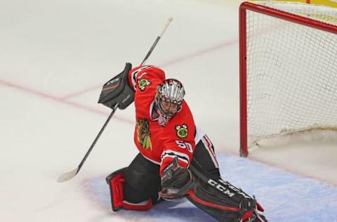 Apr 23, 2016; Chicago, IL, USA; Chicago Blackhawks goalie Corey Crawford (50) makes a glove save during the third period in game six of the first round of the 2016 Stanley Cup Playoffs against the St. Louis Blues at the United Center. Chicago won 6-3. Mandatory Credit: Dennis Wierzbicki-USA TODAY Sports