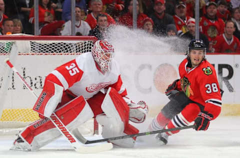 Feb 18, 2015; Chicago, IL, USA; Detroit Red Wings goalie Jimmy Howard (35) is showered with spray from Chicago Blackhawks right wing Ryan Hartman (38) during the first period at the United Center. Mandatory Credit: Dennis Wierzbicki-USA TODAY Sports