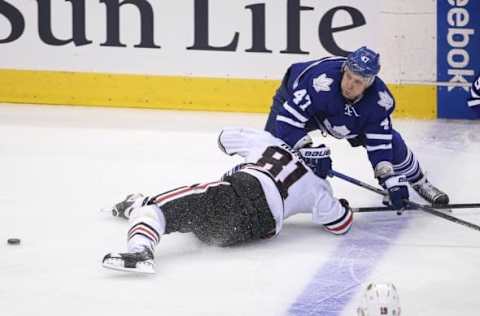 Jan 15, 2016; Toronto, Ontario, CAN; Toronto Maple Leafs center Leo Komarov (47) battles for the puck against Chicago Blackhawks right wing Marian Hossa (81) at Air Canada Centre. The Blackhawks beat the Maple Leafs 4-1. Mandatory Credit: Tom Szczerbowski-USA TODAY Sports