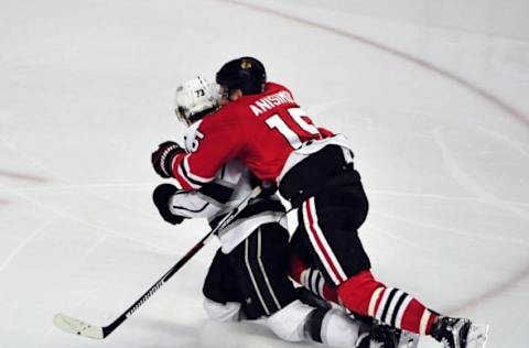 Mar 14, 2016; Chicago, IL, USA; Chicago Blackhawks center Artem Anisimov (15) checks Los Angeles Kings center Tyler Toffoli (73) during the second period at the United Center. Mandatory Credit: David Banks-USA TODAY Sports