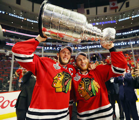 CHICAGO, IL – JUNE 15: Jonathan Toews #19 and Patrick Kane #88 of the Chicago Blackhawks celebrate by hoisting the Stanley Cup after defeating the Tampa Bay Lightning by a score of 2-0 in Game Six to win the 2015 NHL Stanley Cup Final at the United Center on June 15, 2015 in Chicago, Illinois. (Photo by Bruce Bennett/Getty Images)