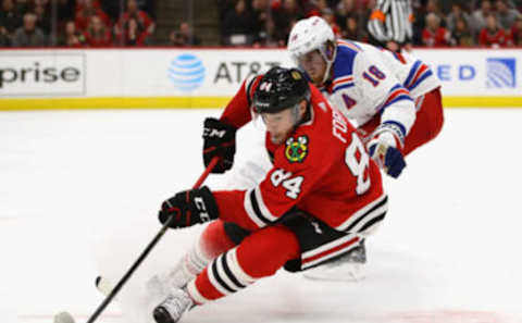 CHICAGO, IL – OCTOBER 25: Alexandre Fortin #84 of the Chicago Blackhawks turns with the puck next to Marc Staal #18 of the New York Rangers at the United Center on October 25, 2018 in Chicago, Illinois. The Blackhawks defeated the Rangers 4-1. (Photo by Jonathan Daniel/Getty Images)