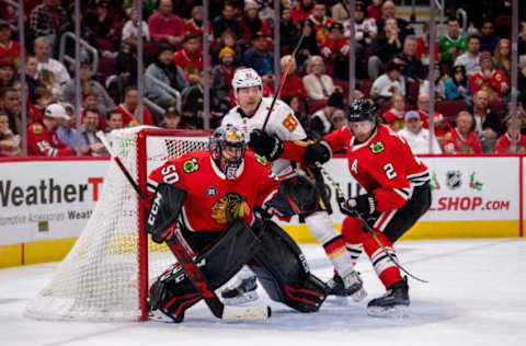 CHICAGO, IL – DECEMBER 02: Chicago Blackhawks goaltender Corey Crawford (50) defends the net against Calgary Flames center Sam Bennett (93) and Chicago Blackhawks defenseman Duncan Keith (2) during a game between the Calgary Flames and the Chicago Blackhawks on December 2, 2018, at the United Center in Chicago, IL. (Photo by Patrick Gorski/Icon Sportswire via Getty Images)