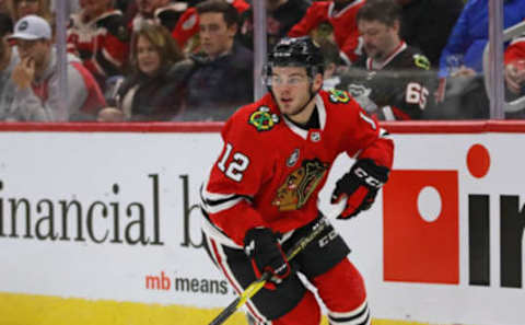 CHICAGO, ILLINOIS – NOVEMBER 27: Alex DeBrincat #12 of the Chicago Blackhawks looks to pass against the Vegas Golden Knights at the United Center on November 27, 2018 in Chicago, Illinois. (Photo by Jonathan Daniel/Getty Images)