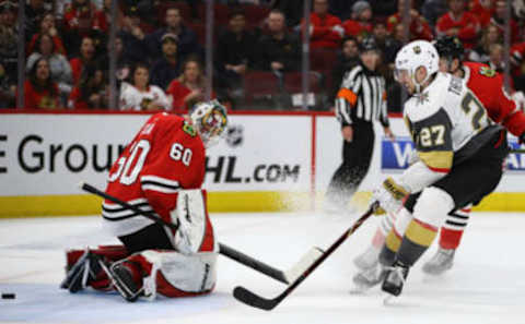 CHICAGO, ILLINOIS – JANUARY 12: Shea Theodore #27 of the Vegas Golden Knights scores the game-winning goal against Collin Delia #60 of the Chicago Blackhawks at the United Center on January 12, 2019 in Chicago, Illinois. The Golden Knights defeated the Blackhawks 4-3 in overtime. (Photo by Jonathan Daniel/Getty Images)