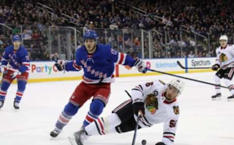 NEW YORK, NEW YORK – JANUARY 17: Jesper Fast #17 of the New York Rangers trips up Erik Gustafsson #56 of the Chicago Blackhawks during the first period at Madison Square Garden on January 17, 2019 in New York City. (Photo by Bruce Bennett/Getty Images)