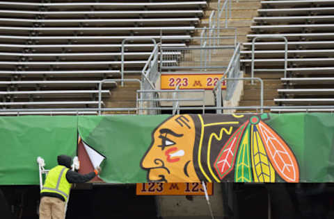 MINNEAPOLIS, MN – FEBRUARY 19: A worker installs a banner with the logo from the Chicago Blackhawks as part of the preparations for the 2016 Coors Light Stadium Series game between the Minnesota Wild and Chicago Blackhawks on February 19, 2016 at TCF Bank Stadium in Minneapolis, Minnesota. (Photo by Jamie Sabau/NHLI via Getty Images)