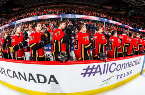 CALGARY, AB – DECEMBER 31: Teammates of the Calgary Flames stand during the national anthem in an NHL game on December 31, 2017 at the Scotiabank Saddledome in Calgary, Alberta, Canada. (Photo by Gerry Thomas/NHLI via Getty Images)