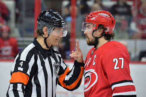 RALEIGH, NC – JANUARY 21: NHL referee Wes McCauley (4) discusses a call with Carolina Hurricanes Defenceman Justin Faulk (27) during a game between the Vegas Golden Knights and the Carolina Hurricanes at the PNC Arena in Raleigh, NC on January 21, 2018. Vegas defeated Carolina 5-1. (Photo by Greg Thompson/Icon Sportswire via Getty Images)