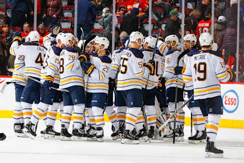 CALGARY, AB – JANUARY 22: Teammates of the Buffalo Sabres celebrate after winning an NHL game against the Calgary Flames on January 22, 2018 at the Scotiabank Saddledome in Calgary, Alberta, Canada. (Photo by Gerry Thomas/NHLI via Getty Images)