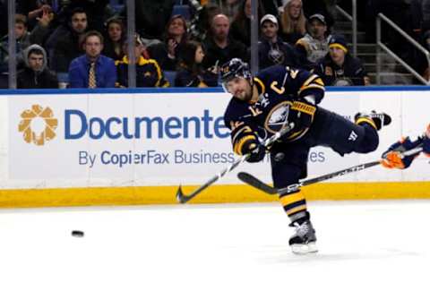 Dec 31, 2015; Buffalo, NY, USA; Buffalo Sabres right wing Brian Gionta (12) takes a shot on goal during the second period against the New York Islanders at First Niagara Center. Mandatory Credit: Timothy T. Ludwig-USA TODAY Sports