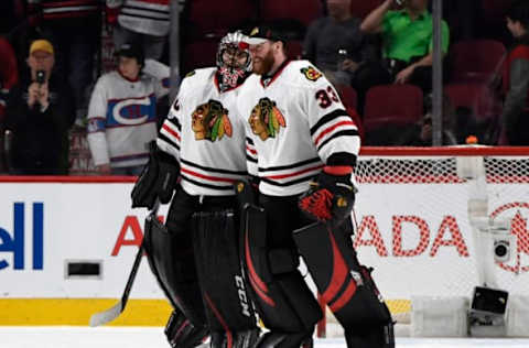 Mar 14, 2017; Montreal, Quebec, CAN; Chicago Blackhawks goalie Corey Crawford (50) reacts with teammate Scott Darling (33) after defeating the Montreal Canadiens at the Bell Centre. Mandatory Credit: Eric Bolte-USA TODAY Sports