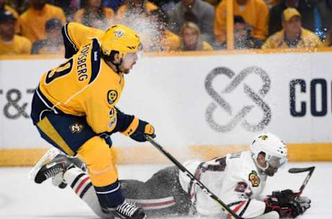 Apr 17, 2017; Nashville, TN, USA; Nashville Predators left wing Filip Forsberg (9) takes the puck from Chicago Blackhawks defenseman Johnny Oduya (27) in game three of the first round of the 2017 Stanley Cup Playoffs at Bridgestone Arena. The Predators won in overtime 3-2. Mandatory Credit: Christopher Hanewinckel-USA TODAY Sports