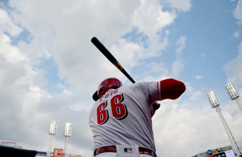 CINCINNATI, OHIO – MARCH 28: Yasiel Puig #66 of the Cincinnati Reds warms up before going up to bat in the seventh inning on Opening Day between the Pittsburgh Pirates and the Cincinnati Reds at Great American Ball Park on March 28, 2019 in Cincinnati, Ohio. (Photo by Bobby Ellis/Getty Images)
