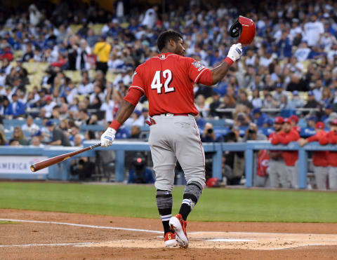 LOS ANGELES, CALIFORNIA – APRIL 15: Yasiel Puig #42 of the Cincinnati Reds tips his hat to an applause, before his first at bat in his return to his former team, during the first inning against the Los Angeles Dodgers on Jackie Robinson Day at Dodger Stadium on April 15, 2019 in Los Angeles, California. All players are wearing the number 42 in honor of Jackie Robinson Day. (Photo by Harry How/Getty Images)