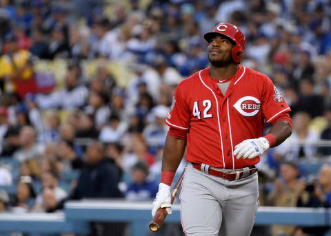 LOS ANGELES, CALIFORNIA – APRIL 15: Yasiel Puig #24 of the Cincinnati Reds reacts during his first at bat in his return to play his former team on Jackie Robinson Day at Dodger Stadium on April 15, 2019 in Los Angeles, California. All players are wearing the number 42 in honor of Jackie Robinson Day. (Photo by Harry How/Getty Images)