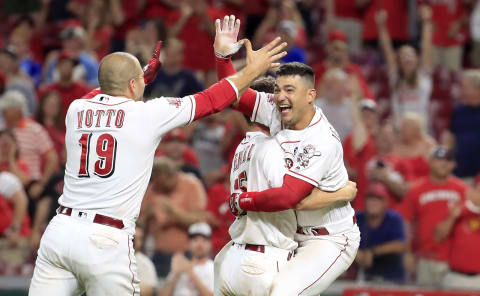 CINCINNATI, OHIO – JULY 02: Joey Votto #19 of the Cincinnati Reds celebrates with Nick Senzel #15 and Jose Iglesias #4 after the 5-4 win in 11 innings against the Milwaukee Brewers at Great American Ball Park on July 02, 2019 in Cincinnati, Ohio. Iglesias hit a game winning single that drove in Yasiel Puig #66 in the 11th inning. (Photo by Andy Lyons/Getty Images)