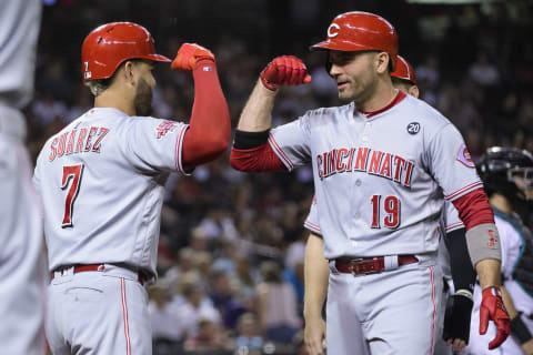 PHOENIX, ARIZONA – SEPTEMBER 13: Joey Votto #19 of the Cincinnati Reds is congratulated by Eugenio Suarez #7 (Photo by Jennifer Stewart/Getty Images)