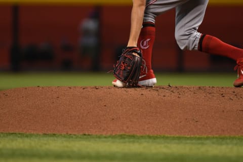 PHOENIX, ARIZONA – SEPTEMBER 15: Trevor Bauer #27 of the Cincinnati Reds picks the ball up off of the pitchers mound. (Photo by Norm Hall/Getty Images)