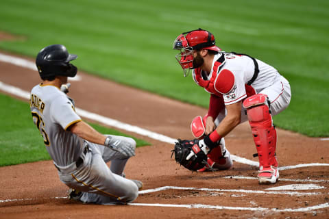 CINCINNATI, OH – SEPTEMBER 14: Adam Frazier #26 of the Pittsburgh Pirates scores a run in the first inning as catcher Curt Casali #12 of the Cincinnati Reds awaits the throw during game two of a doubleheader. (Photo by Jamie Sabau/Getty Images)