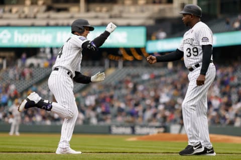 DENVER, CO – MAY 15: Ryan McMahon #24 of the Colorado Rockies is congratulated by third base coach Stu Cole after hitting a two-run home run during the first inning against the Cincinnati Reds. (Photo by Justin Edmonds/Getty Images)