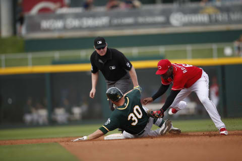 GOODYEAR, AZ – February 28: Alfredo Rodriguez #69 of the Cincinnati Reds tags Austin Allen. (Photo by Michael Zagaris/Oakland Athletics/Getty Images)