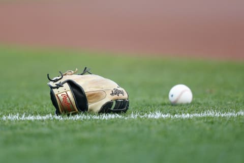 SAN FRANCISCO, CALIFORNIA – APRIL 12: A glove and ball sit on the field before the game between the San Francisco Giants and the Cincinnati Reds. (Photo by Lachlan Cunningham/Getty Images)