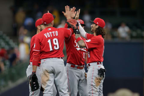 MILWAUKEE, WISCONSIN – JULY 11: Joey Votto #19 and Cincinnati Reds infielders celebrate a win. (Photo by John Fisher/Getty Images)